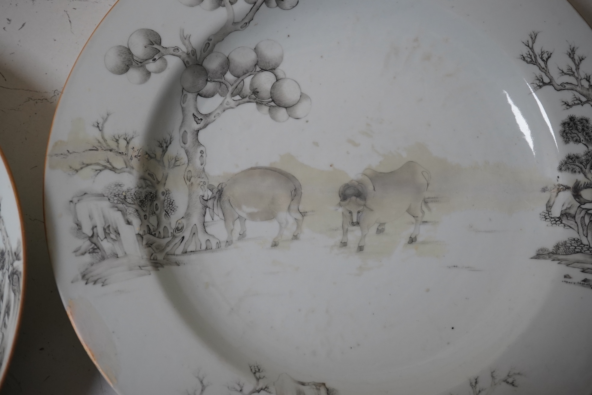 An 18th century Chinese plate and matching bowl decorated with a buffalo and fruit, largest 32cm in diameter. Condition - both a.f.